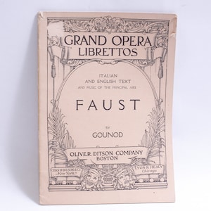 May include: A vintage book cover for a Grand Opera Libretto of Faust by Gounod. The cover is beige with black text and illustrations. The title "Grand Opera Librettos" is at the top, followed by "Faust" in a larger font. The publisher is Oliver Ditson Company, Boston.