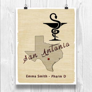 May include: A poster with a vintage aesthetic, featuring a black caduceus symbol above a map of Texas. The text "San Antonio" is written in a cursive font, with "Emma Smith - Pharm D" below. The poster is printed on aged paper.