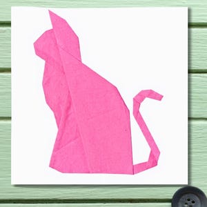 May include: A pink origami cat is depicted on a white background. The cat is sitting with its tail curved upwards. The paper is folded into sharp angles, creating a geometric design. The cat is a vibrant shade of pink.