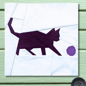 May include: A geometric design featuring a purple cat playing with a purple ball on a white background. The cat is depicted in a simple, angular style, with a long tail and pointed ears. The background is a patchwork of white shapes.
