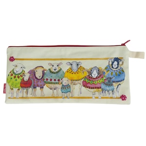 May include: A rectangular, off-white pencil case with a red zipper and a loop. The case features a watercolor illustration of several sheep wearing colorful sweaters. The sheep are arranged in a row against a yellow line.