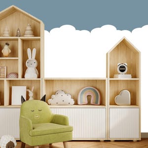 May include: A light green children's armchair with a pig face design, set in a nursery. The room features wooden bookshelves shaped like houses, filled with toys and books. A white cloud and blue sky wallpaper is in the background.