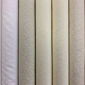 100% cotton fabric classic white designs on white, cream and beige.