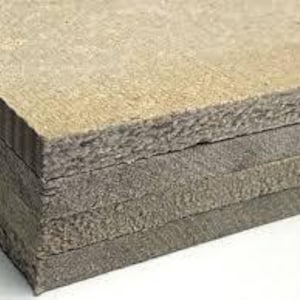 May include: A stack of rectangular, gray-brown composite boards. The boards have a rough, textured surface and appear to be made of layered materials. The edges of the boards show a corrugated pattern.