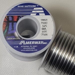 May include: Two spools of solder wire. One spool is labeled "60/40 SAPPHIRE" with "SN60 PB40 .125 DIA" and "MADE IN U.S.A." The other spool is a roll of silver-colored solder wire. The label also includes "MERWAY INC." and "1 LB."
