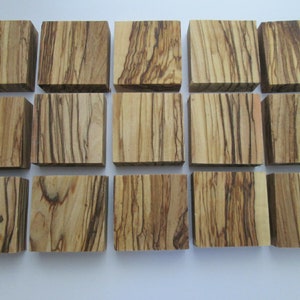 May include: Fifteen square wooden blocks with a brown and light brown wood grain pattern.