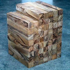 May include: A stack of wooden blocks, each with a unique grain pattern, creating a visually interesting texture. The blocks are arranged in a rectangular shape, showcasing the natural beauty of the wood.