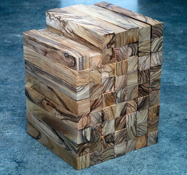 May include: A stack of wooden blocks, each with a unique grain pattern, creating a visually interesting texture. The blocks are arranged in a rectangular shape, showcasing the natural beauty of the wood.