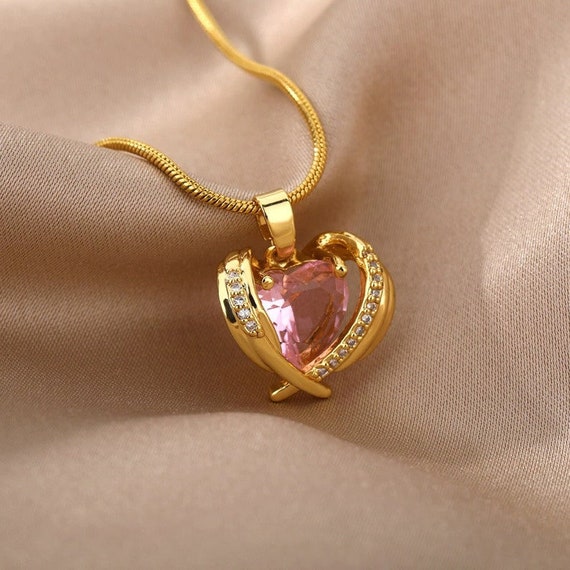 Gold necklace with tiny heart shape pendant and pink Zircons