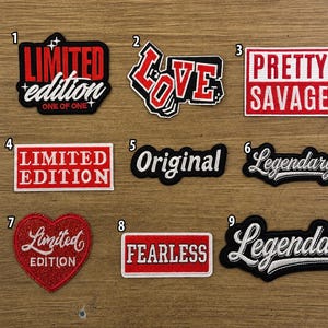 May include: Nine embroidered patches with red, white, and black text designs. Patch 1 says LIMITED EDITION ONE OF ONE, 2 says LOVE, 3 says PRETTY SAVAGE, 4 says LIMITED EDITION, 5 says Original, 6 and 9 say Legendary, 7 says Limited EDITION in a heart, 8 says FEARLESS.
