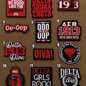 May include: A collection of twelve embroidered patches featuring red, white, and black designs with text including 'There's No Hood Like The Sisterhood', 'Delta Sigma Theta', '1913', 'Oo-Oop', '000 Vibes', 'Diva', 'Delta Girls Rock', and various Greek symbols.