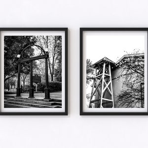 May include: Two black and white framed photographs. The left photo shows a black wrought iron archway with a plaque on the side. The right photo shows a white wooden bell tower with a building behind it.
