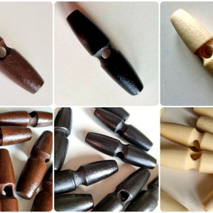 Könnte beinhalten: Holz-Toggle-Knöpfe in verschiedenen Farben: Dunkelbraun, Schwarz und Naturbeige. Diese länglichen Knöpfe haben eine zylindrische Form mit einem zentralen Loch zum Annähen. Ideal für Mäntel, Jacken und andere Kleidungsstücke.