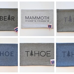 May include: Six decorative pillow covers with different designs. The pillow covers are made of a gray fabric with a subtle texture. The designs include the words "BIG BEAR", "MAMMOTH 37.6308° N, 119.0326° W", and "TAHOE" with a stylized pine tree graphic.