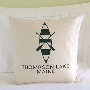 May include: White pillow with a green and black canoe graphic and the text "Thompson Lake Maine".