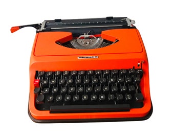 vintage orange, well-working typewriter in hard case