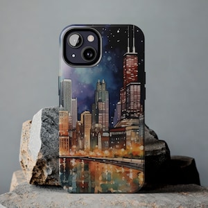 May include: A black phone case featuring a watercolour illustration of the Chicago skyline at night. The case depicts a cityscape with tall buildings and a starry sky.