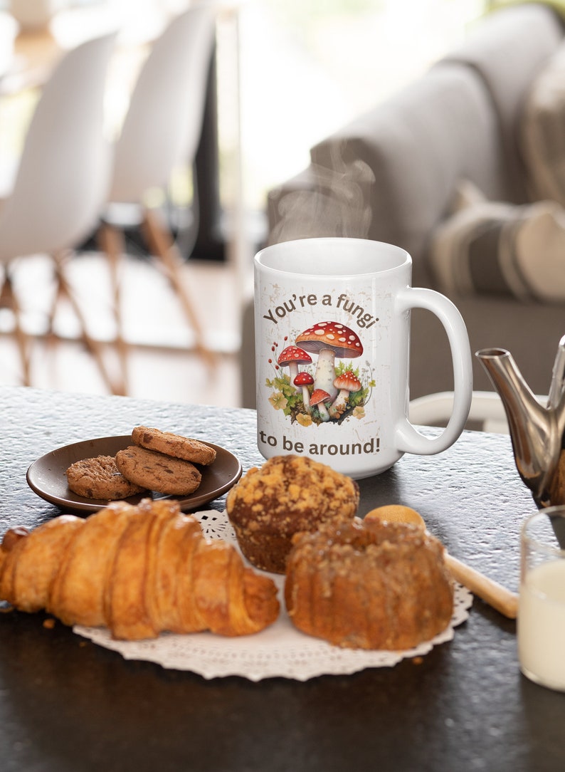 May include: White ceramic mug with a brown and red mushroom illustration and the text "You're a fungi to be around!"