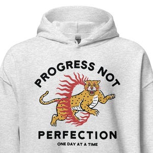 ash Hoodie with the phrase "Progress Not Perfection," a popular recovery and 12 step slogan used in AA and NA.
