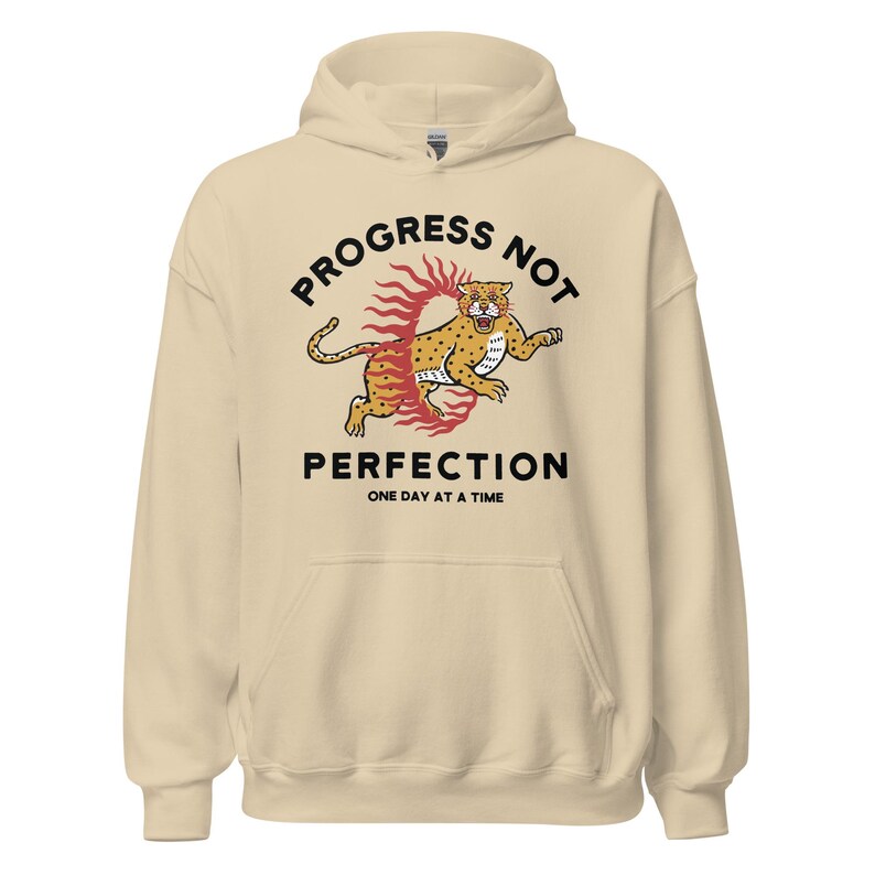 sand Hoodie with the phrase "Progress Not Perfection," a popular recovery and 12 step slogan used in AA and NA.
