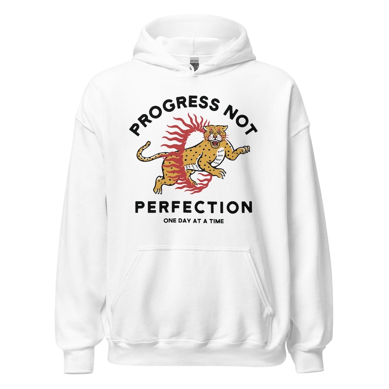 white Hoodie with the phrase "Progress Not Perfection," a popular recovery and 12 step slogan used in AA and NA.