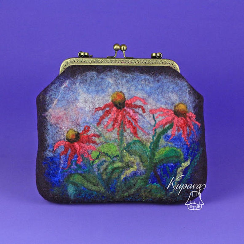 May include: A small, dark brown felt clutch bag with a brass clasp. The bag features a hand-painted design of three red and pink flowers with green leaves against a blue and white background. The text "Kupava" is visible in the lower right corner of the bag.