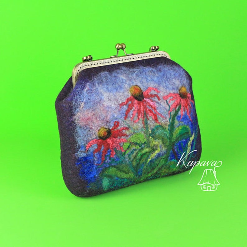 May include: A small, dark blue felt purse with a metal clasp. The purse is decorated with a floral design of pink and red flowers on a blue and green background.