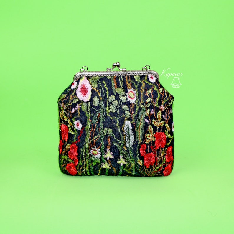May include: A black velvet clutch purse with a floral embroidery design featuring red, pink, and green flowers. The purse has a silver clasp and a chain strap.