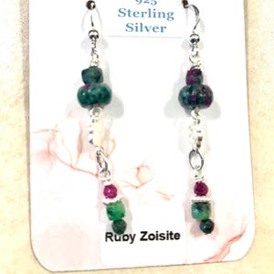May include: Dangle earrings featuring faceted ruby zoisite beads in shades of green and magenta, accented with small silver-toned spacers and hooks. The display card includes the text Deb Curtis Etsy.com 925 Sterling Silver and Ruby Zoisite.