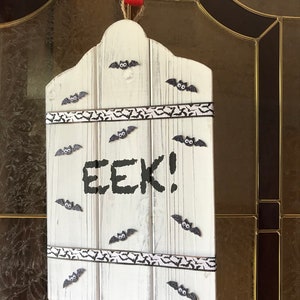 EEK!!!! White Washed Bat Design Sign Welcomes Visitors To Your Halloween Home. Decorated With Flying Bats And Ribbons.