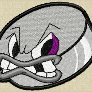 May include: Embroidered patch featuring a cartoon hockey puck with an angry expression. The puck is primarily gray with black and white accents, a purple eye, and a black outline. The design has a stitched texture.