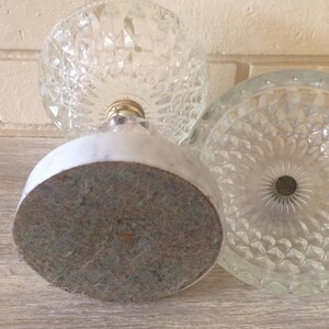 May include: A vintage glass candy dish with a marble base. The dish has a diamond pattern and a gold metal accent.