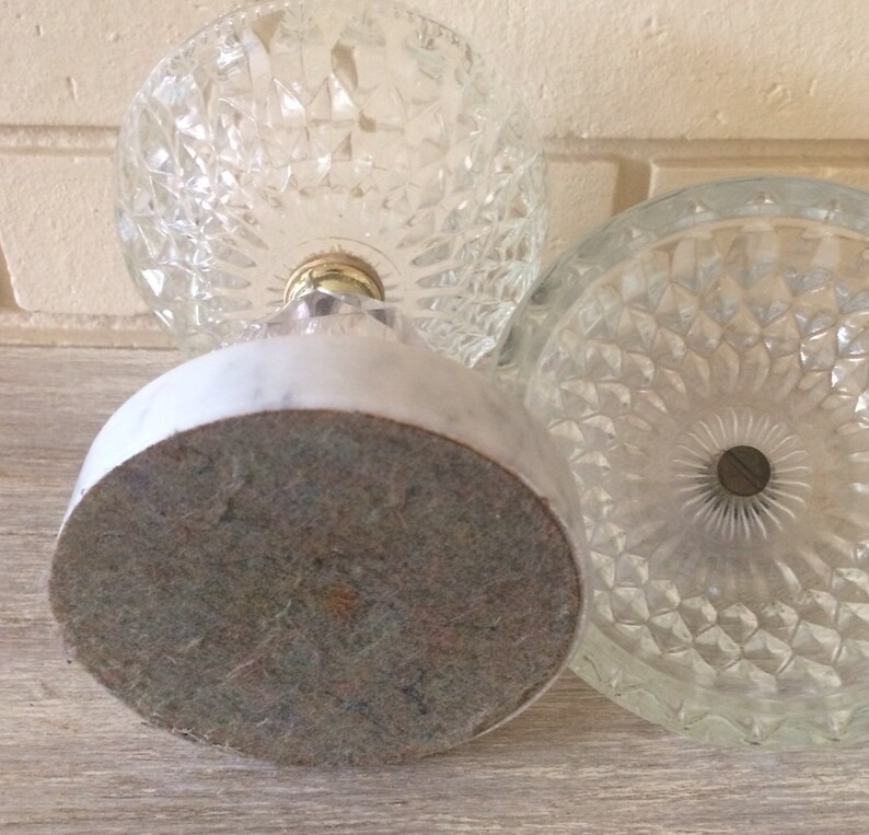 May include: A vintage glass candy dish with a marble base. The dish has a diamond pattern and a gold metal accent.