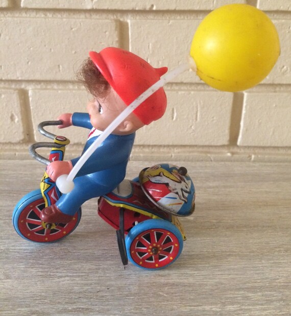 boy riding tricycle