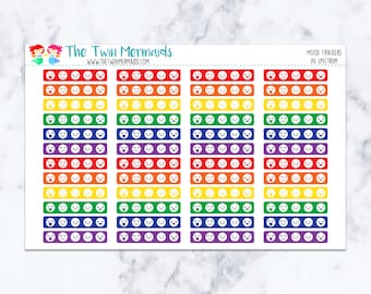 May include: A sheet of colorful mood tracker stickers with a rainbow theme. Each sticker strip features a series of smiley faces in various expressions, from happy to sad. The text "The Twin Mermaids" and "Mood Trackers in Spectrum" are visible.