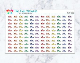 May include: Sheet of colorful athletic shoe stickers. The stickers are in various colors, including red, orange, yellow, green, blue, purple, and pink. The sheet also includes the text "The Twin Mermaids" and "ATHLETIC SHOES".