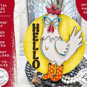May include: A wooden, laser-cut chicken wearing glasses and boots, set against a yellow background with the word "HELLO". The chicken is white with teal accents and orange boots. The sign is designed for home decor.