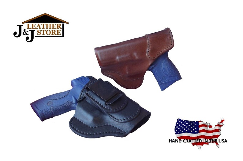 May include: Two leather gun holsters, one brown and one black, each holding a blue handgun. The holsters are shown against a white background. The image includes the text "J&J Leather Store" and a US flag graphic with the text "Hand Crafted in the USA."