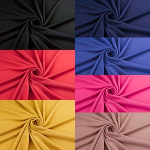 May include: A collection of fabric swatches in various colors, including black, navy blue, red, pink, yellow, and brown. The fabric is arranged in a spiral pattern, showcasing its texture and drape.