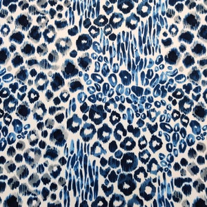 May include: A fabric with a repeating pattern of blue and gray leopard spots and vertical brushstrokes on a white background. The design features varying shades of blue, creating a textured and dynamic appearance. This textile is suitable for various applications.