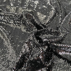 May include: Black fabric with silver sequins in a repeating pattern.