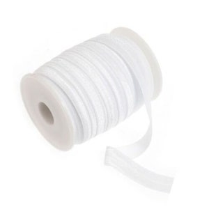 May include: A spool of white elastic ribbon with a slight shimmer. The ribbon is wound around a white plastic spool.