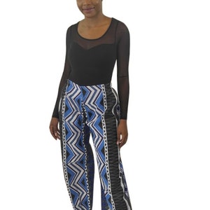 Handmade African wide leg pants for women, featuring authentic Ankara print, elastic waistband, and zip closure. Stylish high waist palazzo trousers with pockets on both sides for comfort and convenience. Perfect for casual outings, work, cultural events, festivals, and vacations. Flowy, breathable, and versatile African print pants designed by OLUDAN Clothing. Pair with tops, blouses, or African accessories for a chic look.