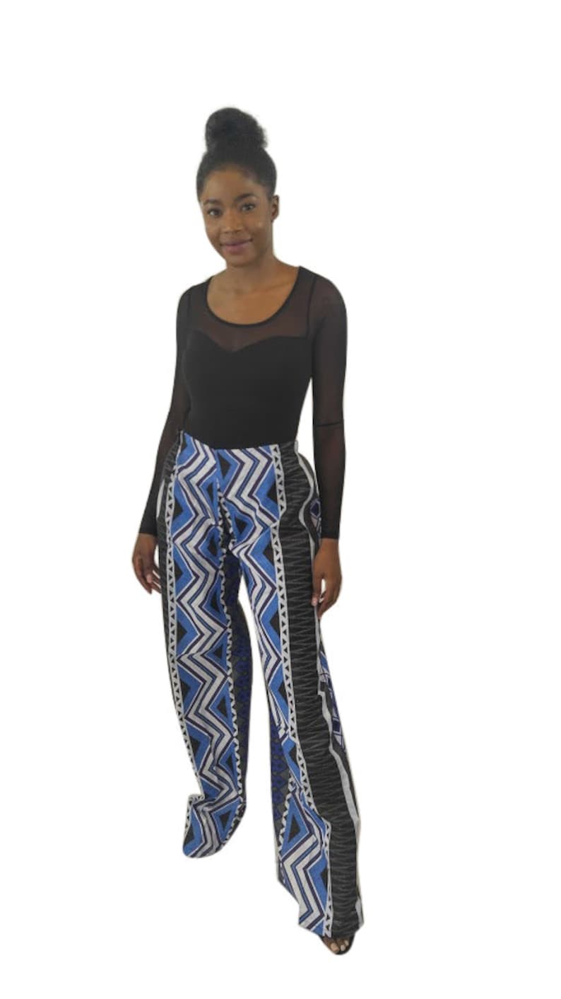 Handmade African wide leg pants for women, featuring authentic Ankara print, elastic waistband, and zip closure. Stylish high waist palazzo trousers with pockets on both sides for comfort and convenience. Perfect for casual outings, work, cultural events, festivals, and vacations. Flowy, breathable, and versatile African print pants designed by OLUDAN Clothing. Pair with tops, blouses, or African accessories for a chic look.