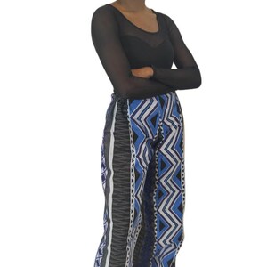 Handmade African wide leg pants for women, featuring authentic Ankara print, elastic waistband, and zip closure. Stylish high waist palazzo trousers with pockets on both sides for comfort and convenience. Perfect for casual outings, work, cultural events, festivals, and vacations. Flowy, breathable, and versatile African print pants designed by OLUDAN Clothing. Pair with tops, blouses, or African accessories for a chic look.