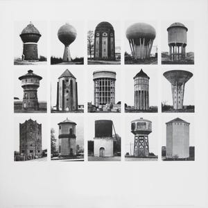 May include: A monochrome print displaying a grid of fifteen water towers. The water towers are diverse in form and design, representing various architectural styles. The image is a study of industrial structures.