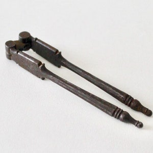 Antique Victorian reversible metal nutcracker. Decorative antique early vintage almond, walnut, chestnut nutcracker. Old nut cracker tool.