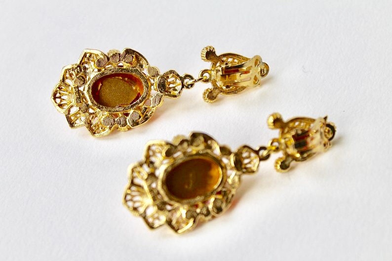 Rhinestones Indian inspired earrings Faux ruby cabochon chandelier earrings. Vintage Sphinx gold and red cabochon dangle clip on earrings