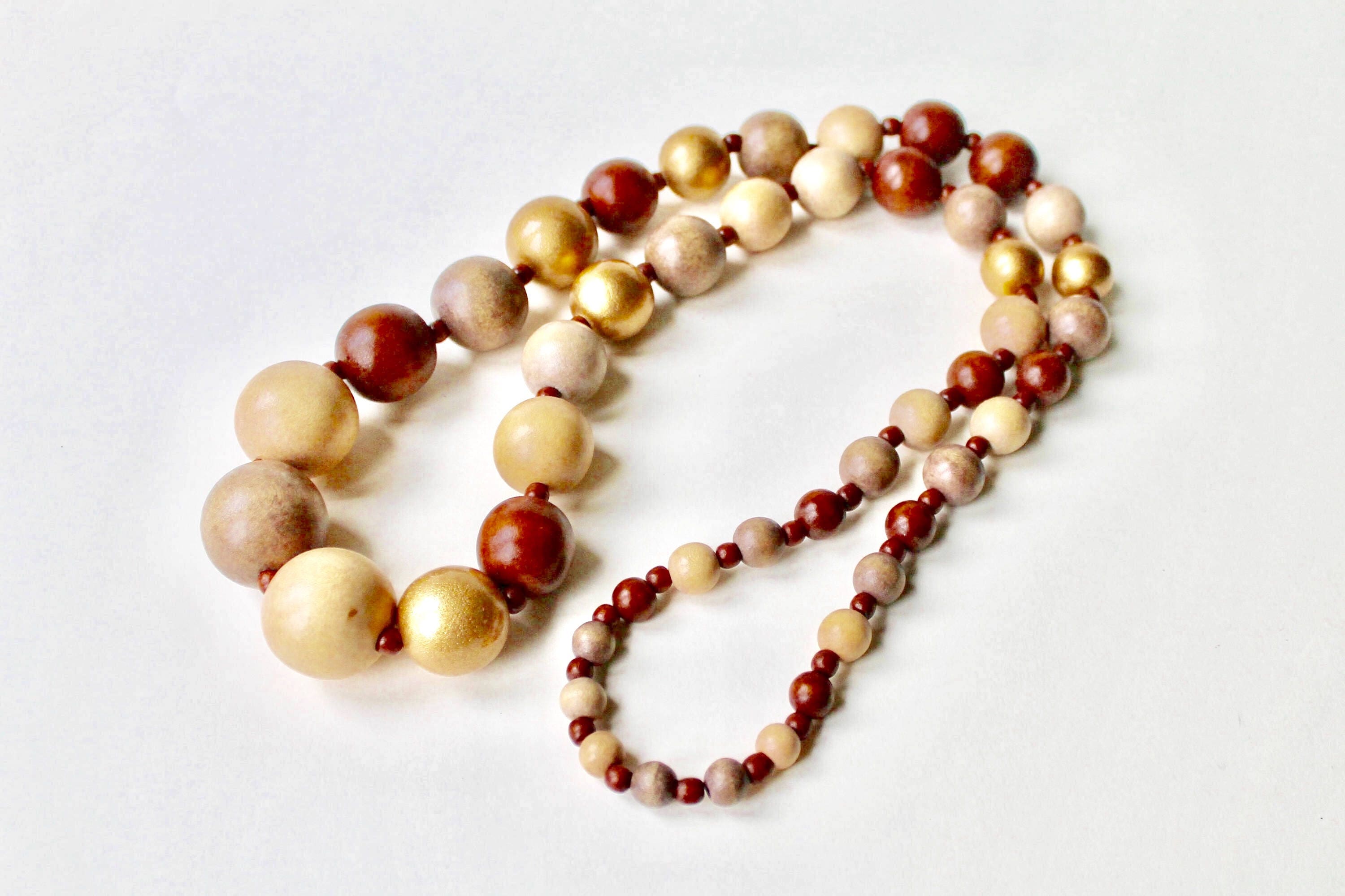 Vintage gold wood bead graduating statement necklace. Wooden graduating ball necklace. 1980's wood bead necklace. Brown, beige, gold beads.