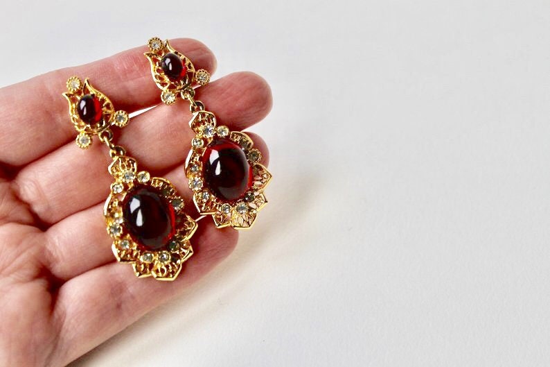 Rhinestones Indian inspired earrings Faux ruby cabochon chandelier earrings. Vintage Sphinx gold and red cabochon dangle clip on earrings